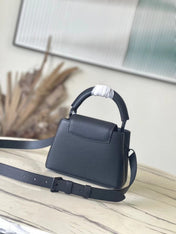 CAPUCINES EAST-WEST MINI 21 IN BLACK TAURILLON